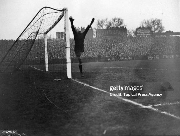Fulham goalkeeper Reynold makes a save during their match against Burnley at Craven Cottage.