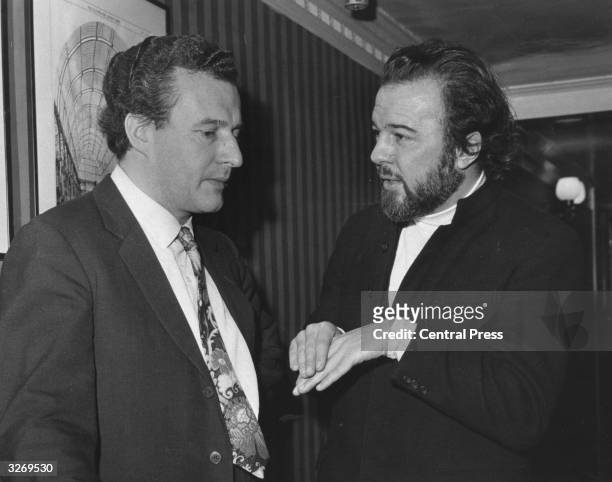 British conductor Colin Davis discussing Sir Michael Tippett's new opera 'The Knot Garden' with producer Peter Hall during the dress rehearsal at the...