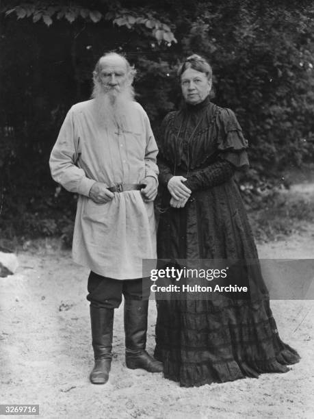 Russian writer Leo Tolstoy in the garden of his Russian home with his wife Sonya .