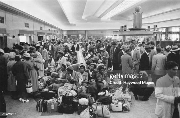Crowd of 700 West Indian immigrants in the customs hall at Southampton. Original Publication: Picture Post - 8405 - Thirty Thousand Colour Problems -...