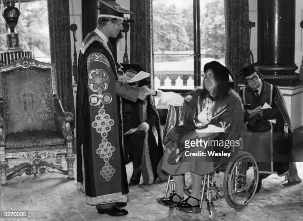 The Duke of Edinburgh shakes hands with the famous cellist, Jacqueline du Pre, after presenting her with a Salford University honorary degree in the...