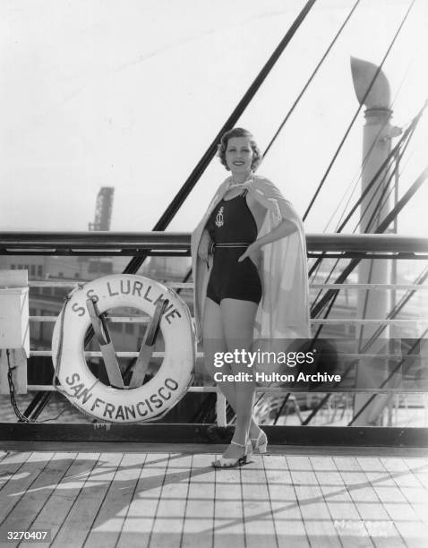 Metro Goldwyn Mayer actress Irene Hervey on board the SS Lurline, wearing a henna wool bathing suit and a terry towelling robe.