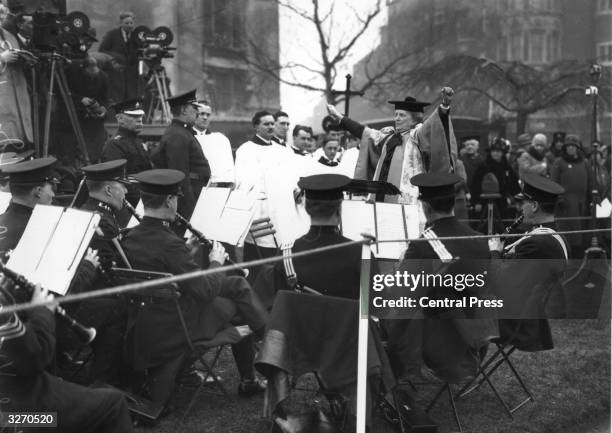 English composer and suffragette Dame Ethel Smyth conducts the Police Band, during the ceremony to unveil the Pankhurst Statue in Victoria Tower...