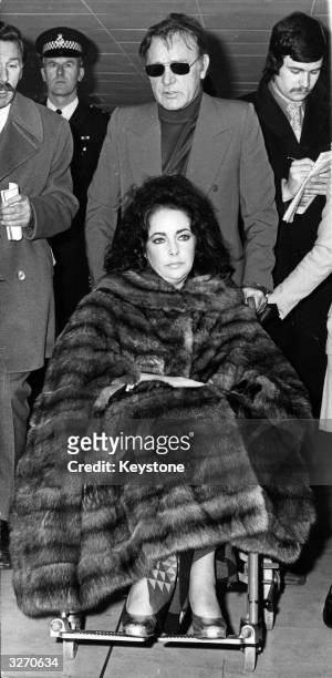 Actress Elizabeth Taylor, who is recovering from an operation for the removal of an ovarian cyst, with her husband, Welsh actor Richard Burton , at...