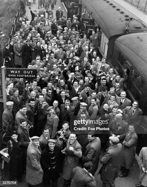 Crowd of Norwich City FC supporters on arrival at Northumberland Park Station, Tottenham, north London, bound for a FA Cup-tie match against...