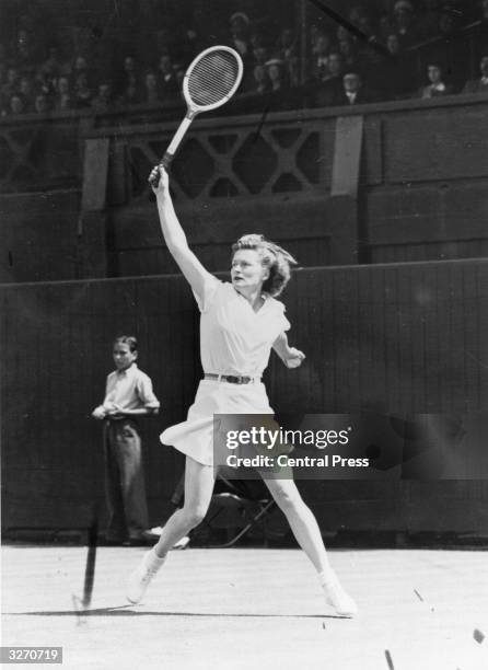 Pauline Betz of the United States in action against Louise Brough during the women's singles final at Wimbledon, which Betz won.