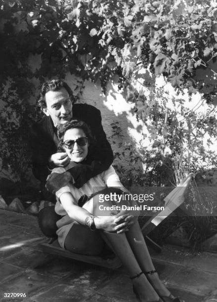 Spanish surrealist artist Salvador Dali and his wife Gala at their villa at Port Lligat near Cadaques in Spain. Original Publication: Picture Post -...