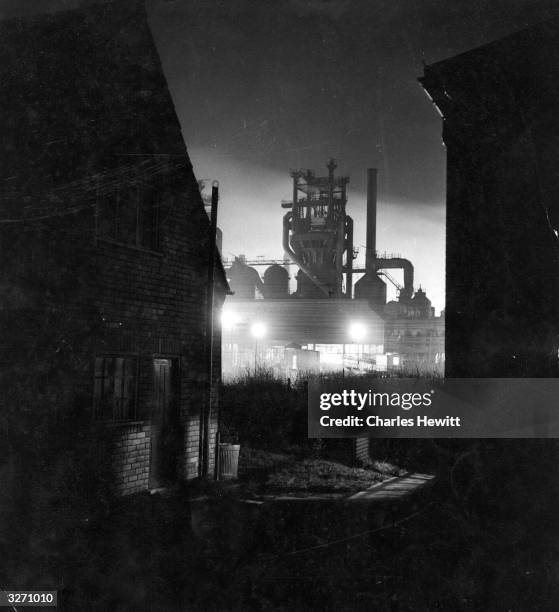 Corby Ironworks in Northamptonshire at night. Original Publication: Picture Post - 4975 - Did You Know This Was Happening To England? - pub. 1950