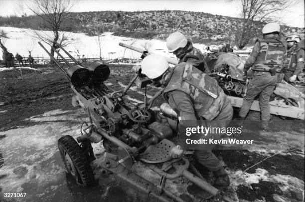 French United Nations troops checking Serbian guns under their control after the NATO deadline.