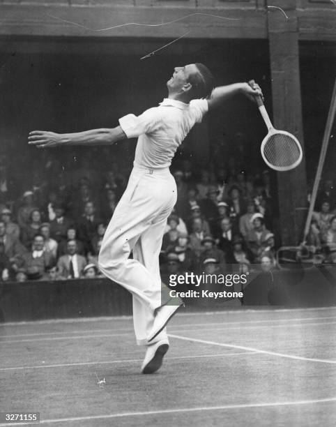 British tennis player Fred Perry in action at Wimbledon.