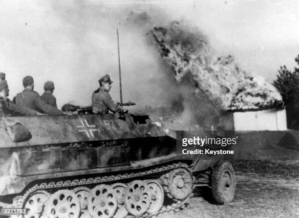 German troops making a dash to escape in the Crimea are cut off by Russian forces. An armoured personnel carrier is seen rushing through a burning...