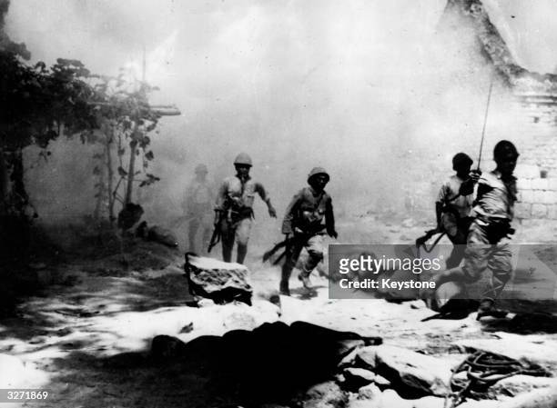 Japanese troops rushing in to attack the burning camp of Chinese soldiers at Vhangsha, one of the most important of Chiang Kai Shek's positions.