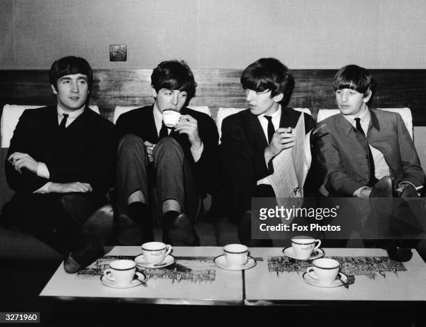 The Beatles take a break from their rehearsals for the Royal Variety Performance at the Prince of Wales Theatre, with a coffee after lunch at the...