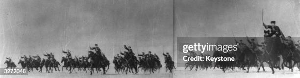 Cossacks troops charge into action on horseback, swords raised.