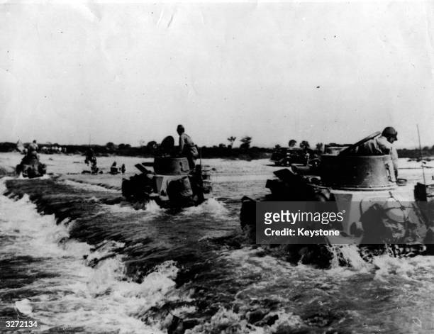 Group of Japanese tanks crossing a river in China. Original Publication: Picture Post - Japan's Army Has Learned War In A Grim And Painful School -...