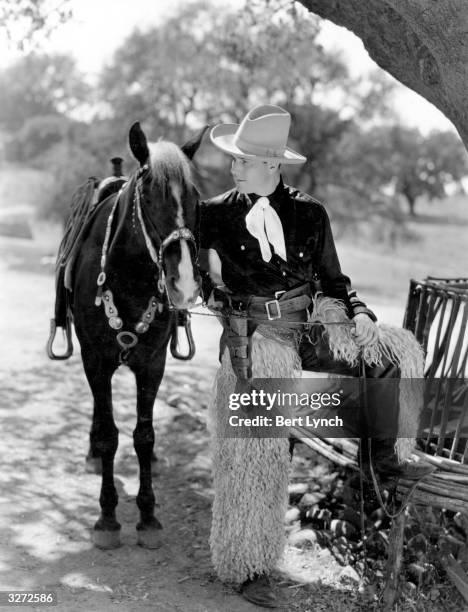 William Haines , American leading man, and his horse Oliver in the first Western he ever appeared in, 'Way Out West', directed by Fred Niblo for MGM.