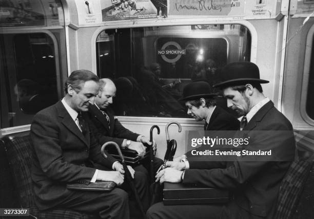 Tired passengers on the London Underground.