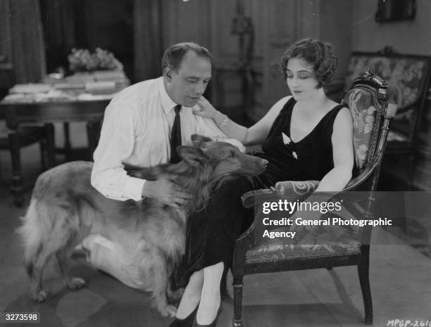 American actress Pauline Frederick with her dog and the director of 'Mrs Paranor' during a break in the MGM film which is adapted from the novel by...