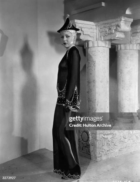 One of the beauty chorus dressed in Chinese costume in a scene from the film 'International House', directed by A Edward Sutherland for Paramount.