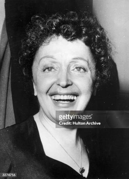 French singer Edith Piaf , originally Edith Giovanna Gassion, smiling broadly after appearing in a music hall variety performance.