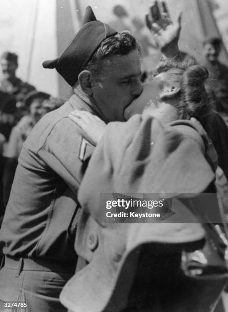 In the excitement of the celebrations following news of Japan's surrender, an American soldier kisses a London girl in Piccadilly Circus.