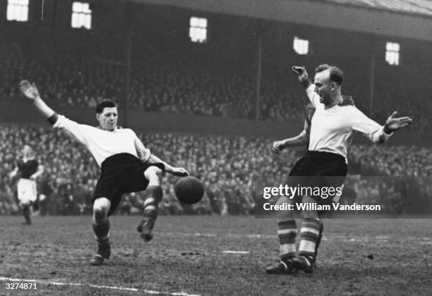 Robert Paisley on the left plays for Liverpool with his goalkeeper, Sidlow watching in their cup match against Burnley. Original Publication: Picture...