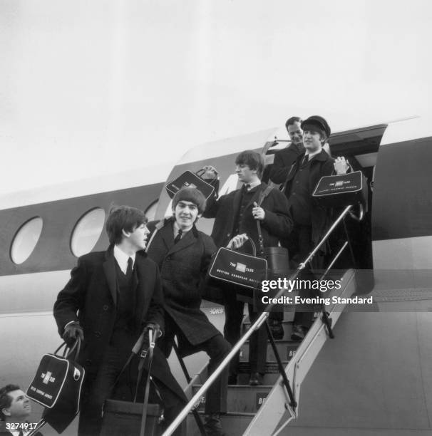 The Beatles, from left to right: Paul McCartney, George Harrison , Ringo Starr and John Lennon , arrive at London Airport with manager Brian Epstein.