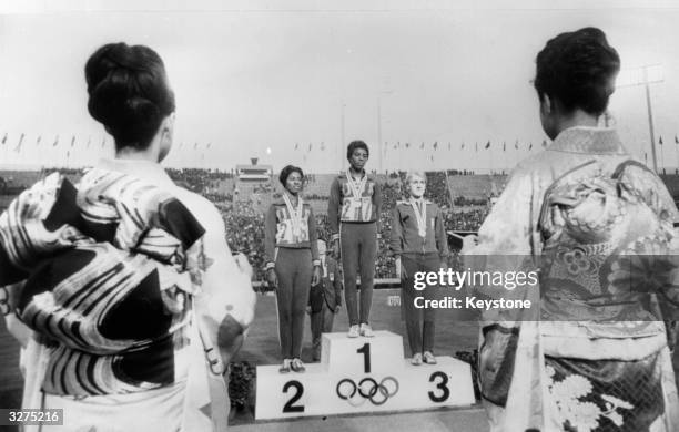 Left to right on the winners podium at the Olympic Games in Tokyo: Edith McGuire , Wyomia Tyus American winner of the Women's 100m, and Ewa...