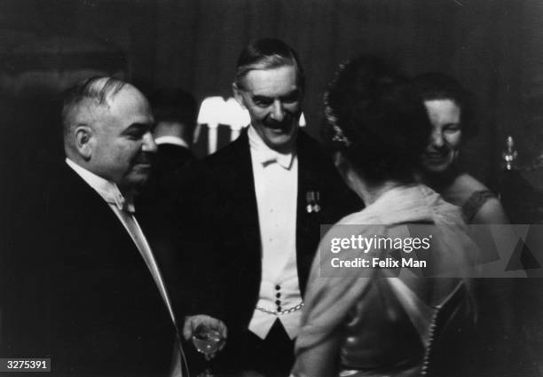 The Russian Ambassador to Britain, Ivan Mikhailovich Maisky , and British Prime Minister Arthur Neville Chamberlain , talk at a party given in the...