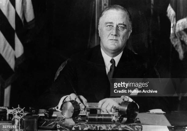 American President Franklin Delano Roosevelt at his desk.