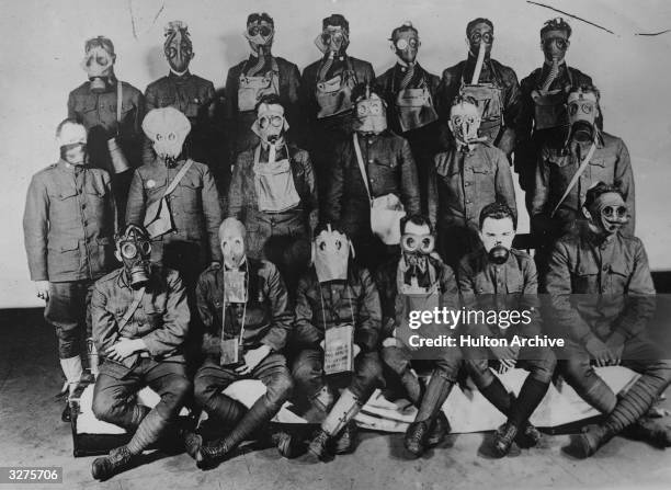Soldiers wearing different styles of gas masks used by Allied and German forces during the First World War.