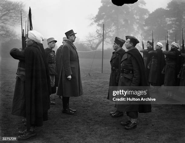 General Charles de Gaulle, leader of the Free French Army, inspects a contingent of French Colonial Troops who rallied to his side after the...