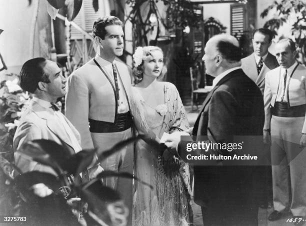 American actors Fred MacMurray and Carole Lombard get married in a scene from 'Swing High, Swing Low', the story of a talented trumpeter who goes on...
