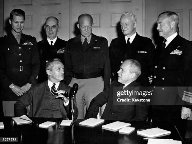 Admiral Chester W Nimitz, the Commander in Chief of the American Pacific Fleet, with a number of other military leaders who are discussing President...