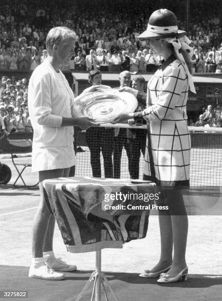 English tennis player Ann Jones being presented with the trophy by Princess Anne after beating Billie Jean King of the USA in the women's singles...