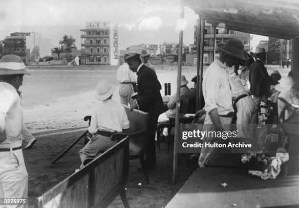 British colonials wearing pith helmets in East Africa.
