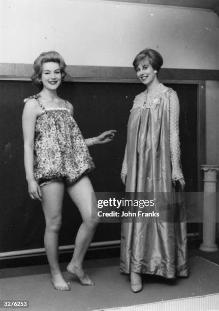 Cathrine Burgess wears a 160 year old maternity dress while her companion, Jane Trevor models a moderm maternity swimming costume.