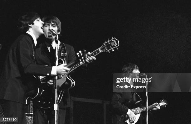 The Beatles, from left to right: Paul McCartney, George Harrison and John Lennon , in concert in America.