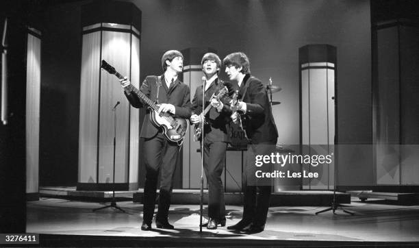 The Beatles, from left to right: Paul McCartney, John Lennon and George Harrison , performing at the London Palladium for the TV show, 'Val Parnell’s...