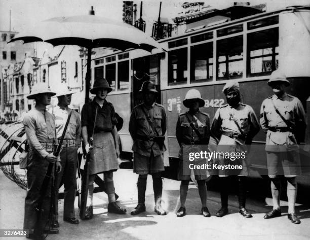 Just before the British left China, these gentlemen met up for a photo session. There is an American Marine, a British 'Tommy', a Chinese Policeman,...