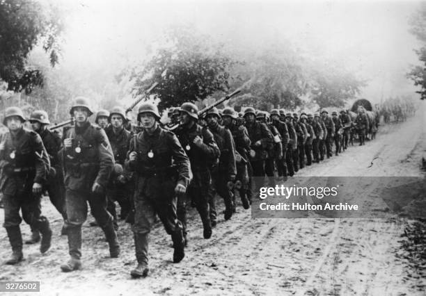 German troops marching through the Polish mud to the front lines.