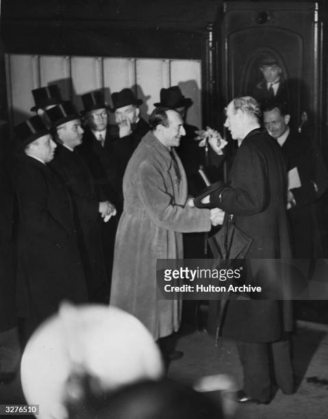 Lord Halifax greeting Colonel Beck , the Polish ambassador, on his arrival at Victoria Station.