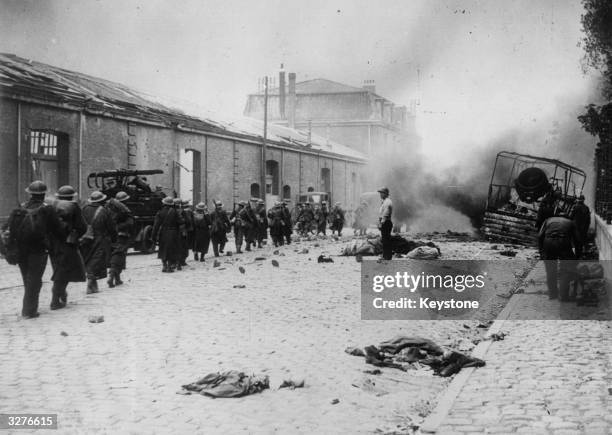 Street in Dunkirk under heavy bombardment during the German attempt to take the town before the evacuation of the allied armies. A column of British...