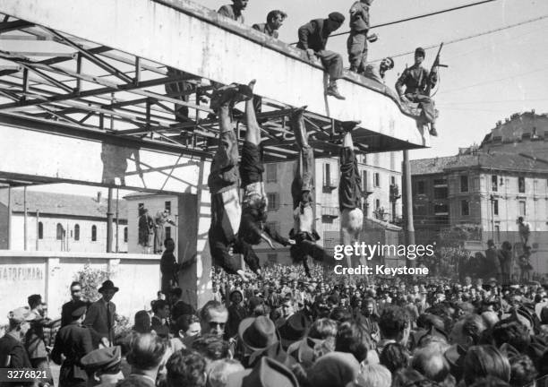 The bodies of Benito Mussolini and Clara Petacci, his mistress, hang from the roof of a gasoline station in Piazzale Loreto, Milan, after they had...