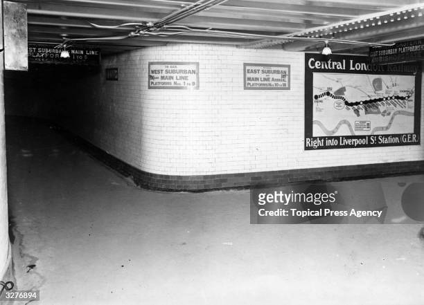 Poster showing the extension of the Central Line on the London Underground, to Ealing, at Liverpool Street Station.