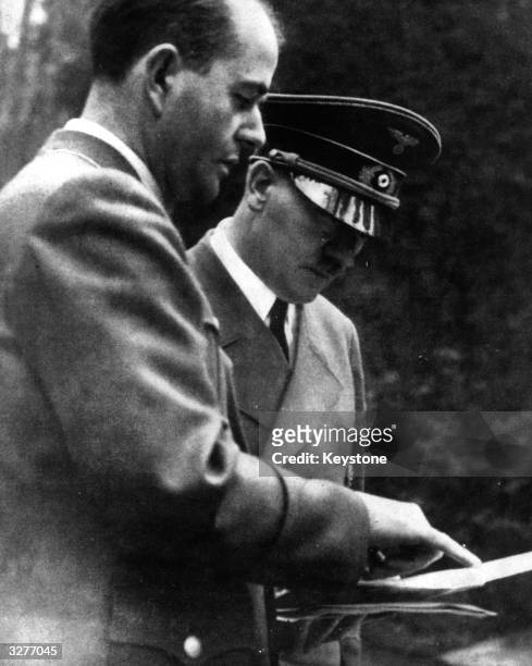 German dictator Adolf Hitler in conversation with architect Albert Speer , Nazi Minister for War Production, about the progress of the 'Atlantic...