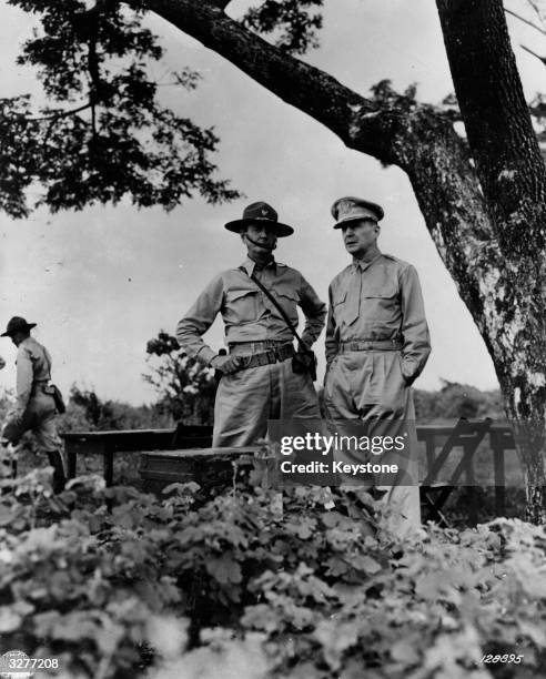 General Douglas MacArthur , US Commander of the forces in the Far East and, from 1942, the Allied Forces, watching field manoeuvres with Australian...