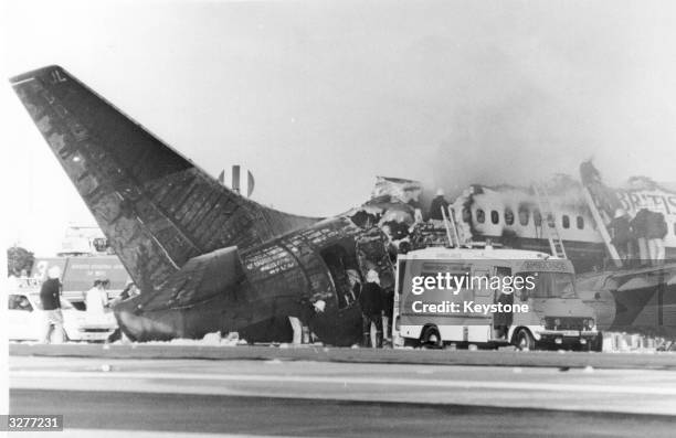 Emergency services at work on the Boeing 737 which burst into flames during take-off at Manchester Airport. Fifty-four people lost their lives on the...