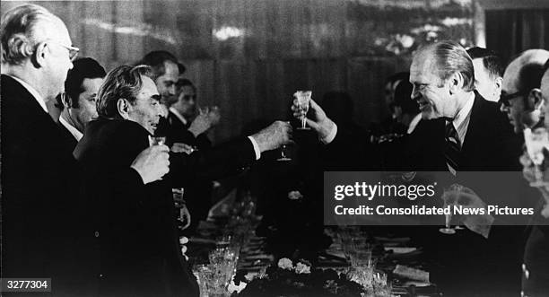 American statesman Gerald Ford, the 38th President of the United States, and Soviet leader Leonid Brezhnev share a toast at their final dinner at...