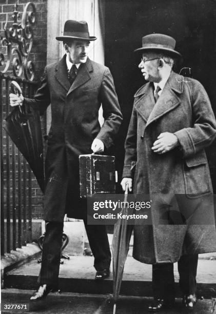 Anthony Eden to the left of J H Thomas, leaving the Foreign Office in London.